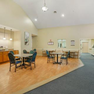 A spacious dining area featuring tables and chairs, ideal for social gatherings or meals.