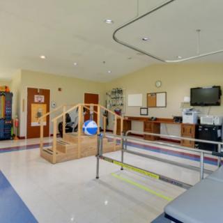 A well-equipped rehabilitation center with various physical therapy apparatus.