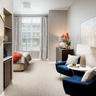 A modern and cozy bedroom featuring stylish furniture and elegant decor.