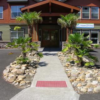Welcoming entrance with tropical landscaping and a clear pathway.