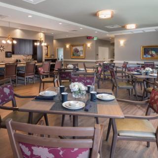 A cozy dining area with neatly arranged tables and chairs, ready for guests.
