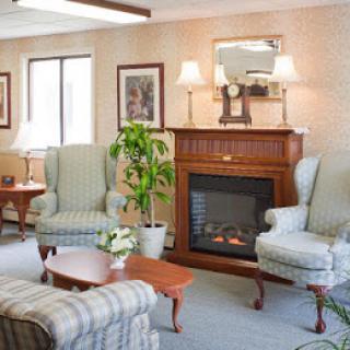 A cozy living room with traditional furniture and a fireplace.