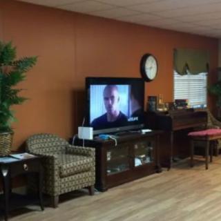 A cozy living room with a television and comfortable seating.
