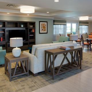 A cozy living room with comfortable seating, a bookshelf, and stylish decor.