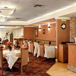 A well-decorated restaurant dining area with neatly arranged tables and chairs.