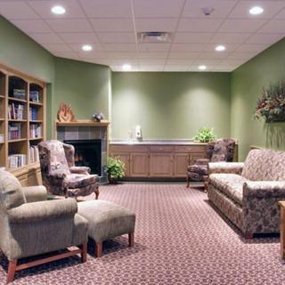 A cozy living room with comfortable seating and a bookshelf.