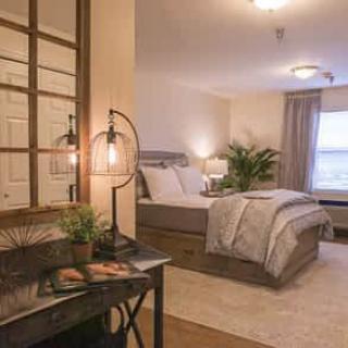 A cozy, modern bedroom with stylish decor and furnishings.