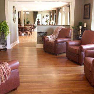 A cozy living room featuring leather chairs and hardwood flooring.