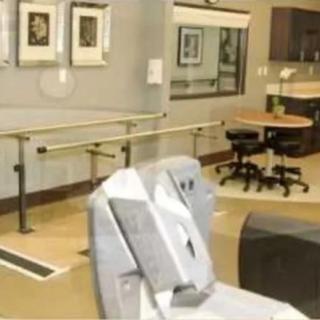 A rehabilitation clinic featuring exercise equipment and parallel bars for patient therapy.