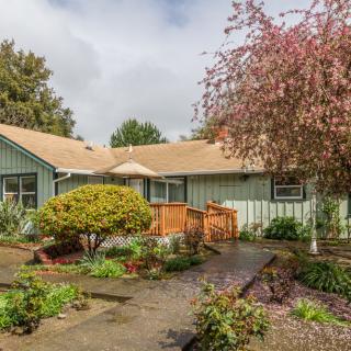 A charming house with a well-maintained garden and pathway.