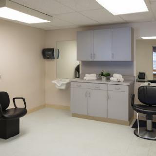 A clean and organized medical office setup, featuring waiting chairs and a countertop.