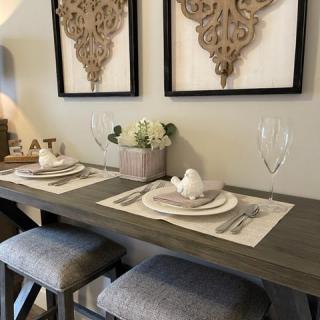 A stylish dining area with a modern table setting and decorative wall art.