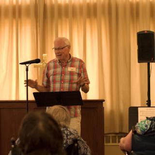 A speaker engaging with an audience during a presentation.
