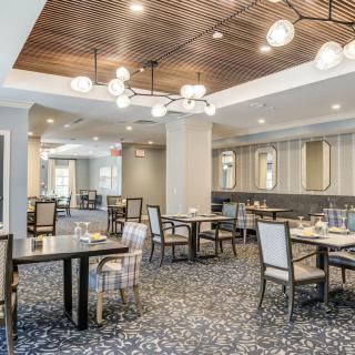 A modern dining area with stylish lighting and well-arranged tables and chairs.