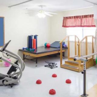 A physical therapy room equipped with exercise machines and tools for rehabilitation.