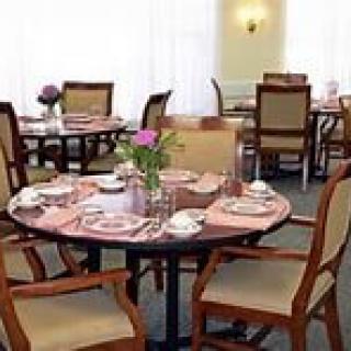A neatly set dining table with flowers in a restaurant.