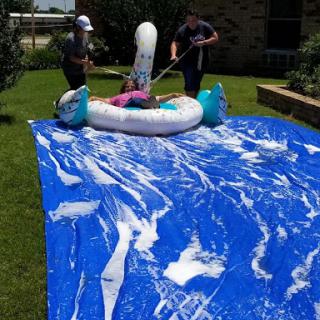 Enjoying a sunny day with a homemade slip and slide adventure!