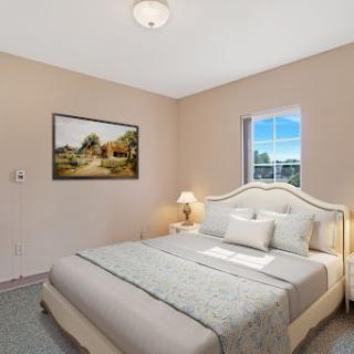 A cozy and inviting bedroom featuring soft colors and a serene atmosphere.