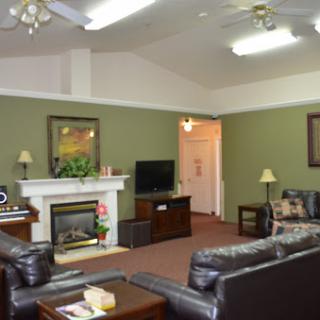 A cozy living room featuring a fireplace, comfortable sofas, and warm lighting.