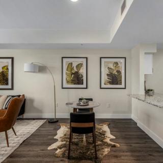 A modern living room with stylish decor and artwork on the walls.