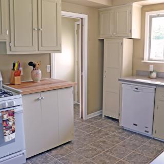 A cozy kitchen with cream-colored cabinets and modern appliances.