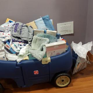 A toy wagon filled to the brim with a variety of medical supplies and clutter.