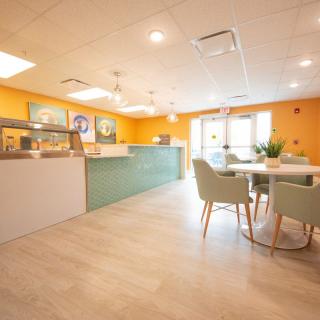 A modern cafe interior with bright colors and a welcoming seating area.