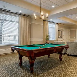 A well-appointed living room featuring a billiard table and elegant decor.