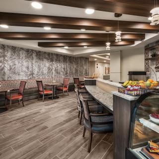 A modern cafe interior featuring comfortable seating and a stylish counter.