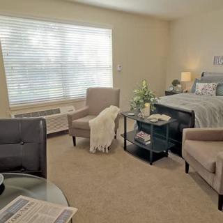 Cozy bedroom with elegant furniture and soft lighting.