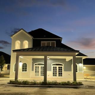 A beautifully illuminated modern house at dusk.