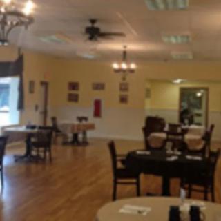 A cozy restaurant dining area with neatly arranged tables and chairs.