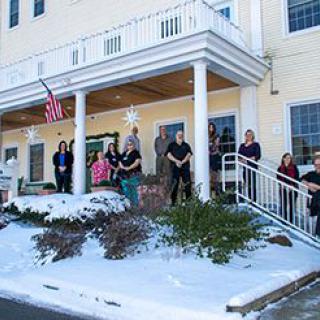 A group of people standing outside a building in winter.