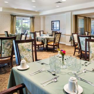 An elegant dining room with neatly arranged tables and chairs, ready for guests.