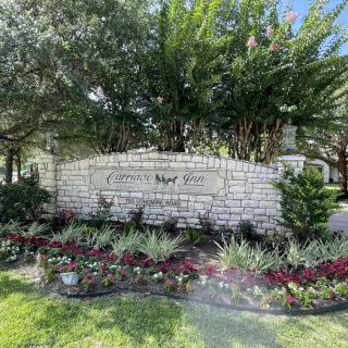 Entrance sign for Clear Water Pond with landscaped surroundings.
