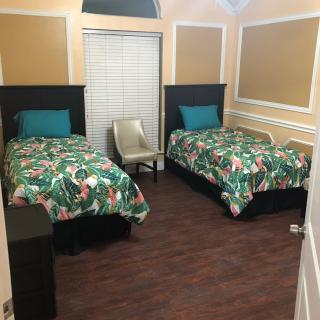 A cozy bedroom with twin beds and vibrant bedding.