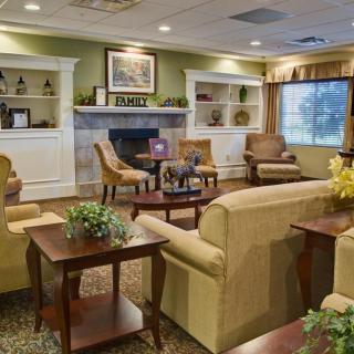 A cozy living room with comfortable seating and a fireplace.