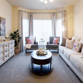 A cozy living room with a comfortable sofa, stylish coffee table, and bright natural lighting.