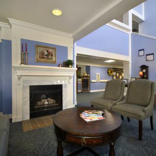 A cozy living room with a fireplace and comfortable seating area.