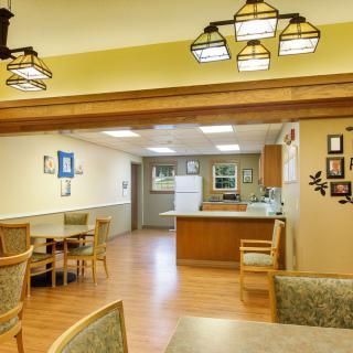 A cozy kitchen and dining area with wooden floors and warm lighting.