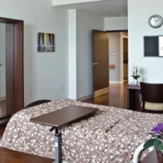 A modern bedroom with a neatly made bed and stylish decor.