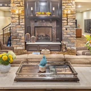 A cozy living room featuring a stone fireplace, stylish sofa, and elegant table decor.