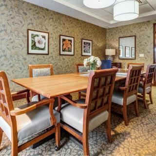 Elegant dining room with wooden furniture and decorative artwork on the walls.