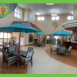 Spacious indoor area with tables, chairs, and umbrellas providing a relaxed atmosphere.