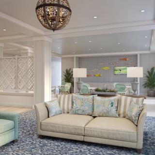 A beautifully decorated living room featuring a comfortable sofa, elegant chandelier, and stylish decor.