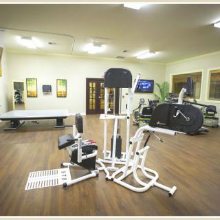 A well-equipped gym with a variety of fitness machines and exercise equipment.