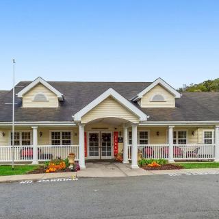 A charming residential building with a welcoming front porch.