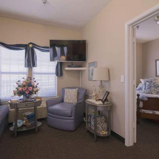 A cozy living room with a comfortable chair, television, and decorative elements.