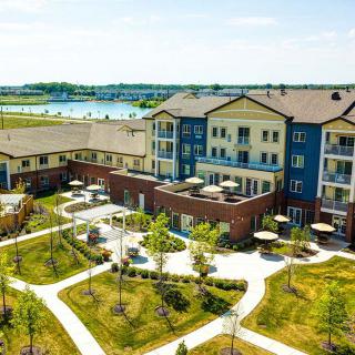 Aerial view of a residential apartment complex surrounded by greenery and pathways.