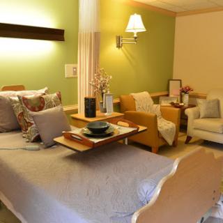 A cozy and colorful bedroom featuring a comfortable bed and inviting sitting area.